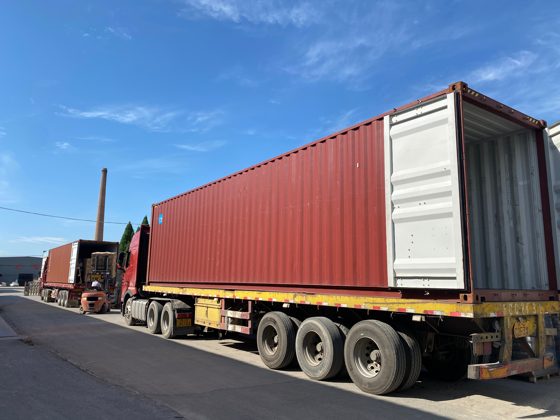 Forklift loading 40ft container with palletized perfume bottles