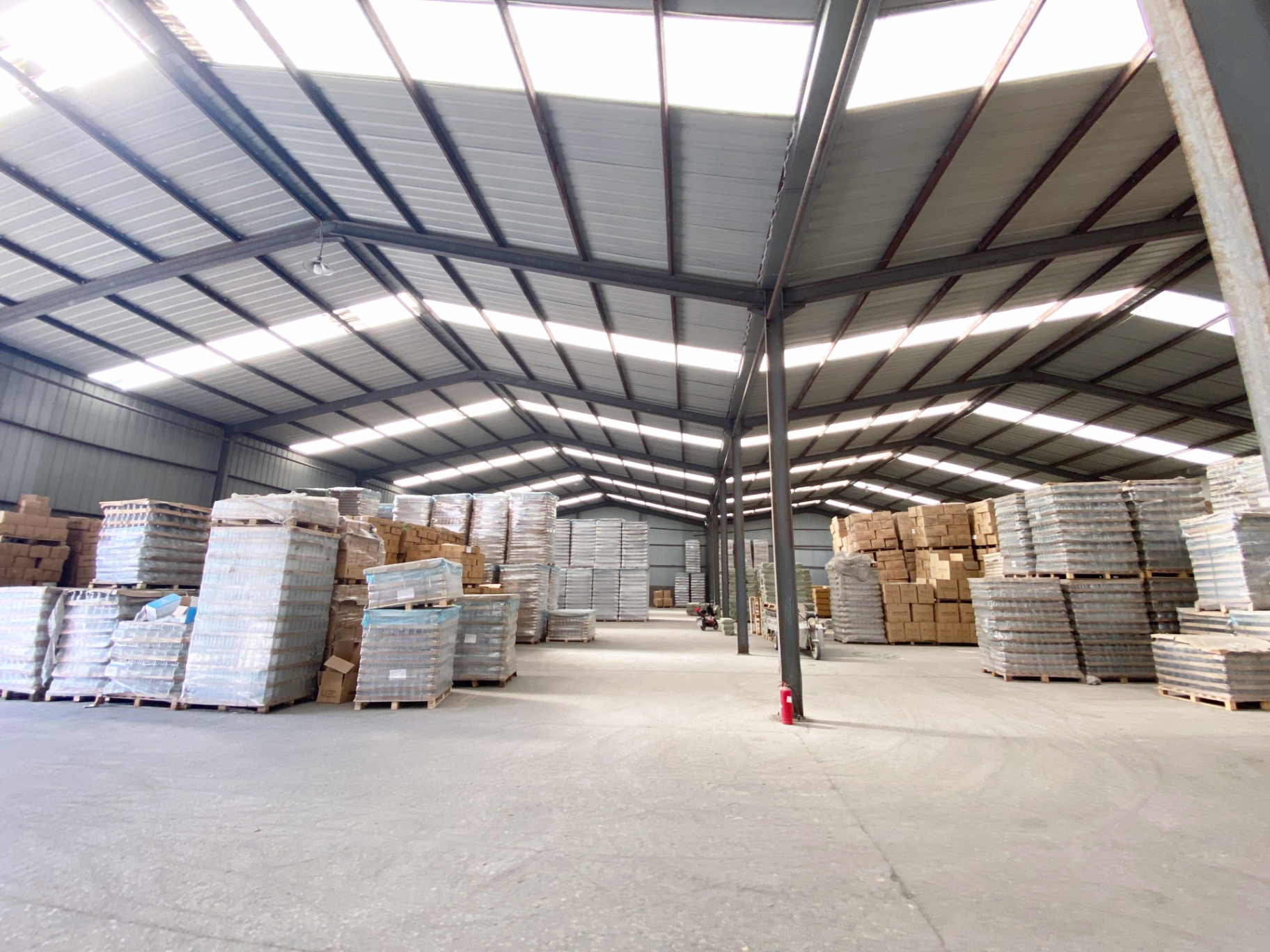Interior view of the finished-goods warehouse with rows of glass bottle inventory